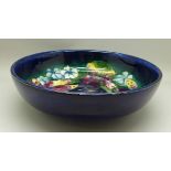 A Moorcroft orchid bowl, with impressed signature and To H.M. The Queen mark, 22cm diameter