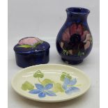 A Moorcroft vase, pin dish and lidded pot, vase 9.5cm a/f, (47, 56, 59)