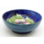A small Moorcroft pansy bowl, with paper label, By Appointment to H.M. The Queen, 78mm diameter