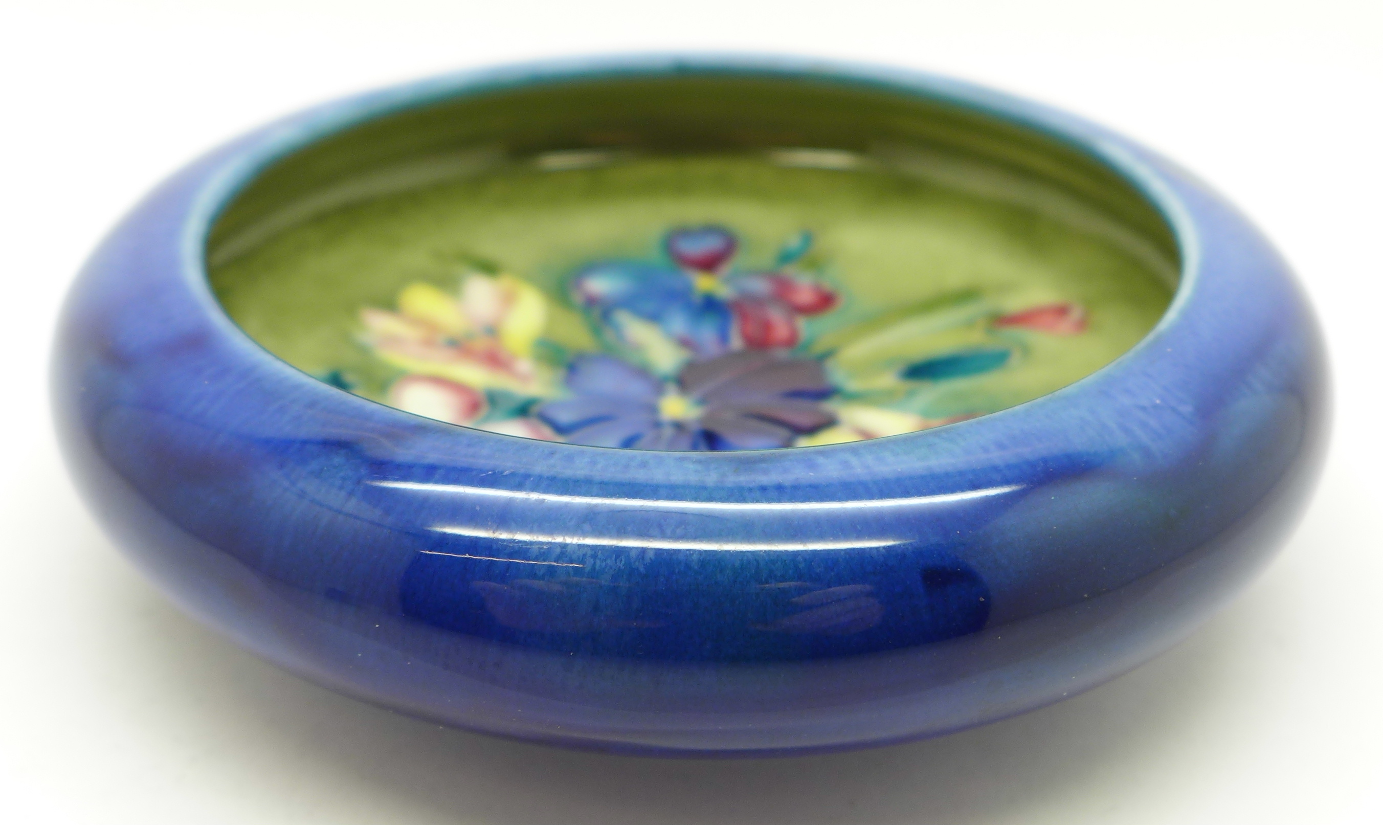 A Moorcroft spring flowers dish, 108mm diameter