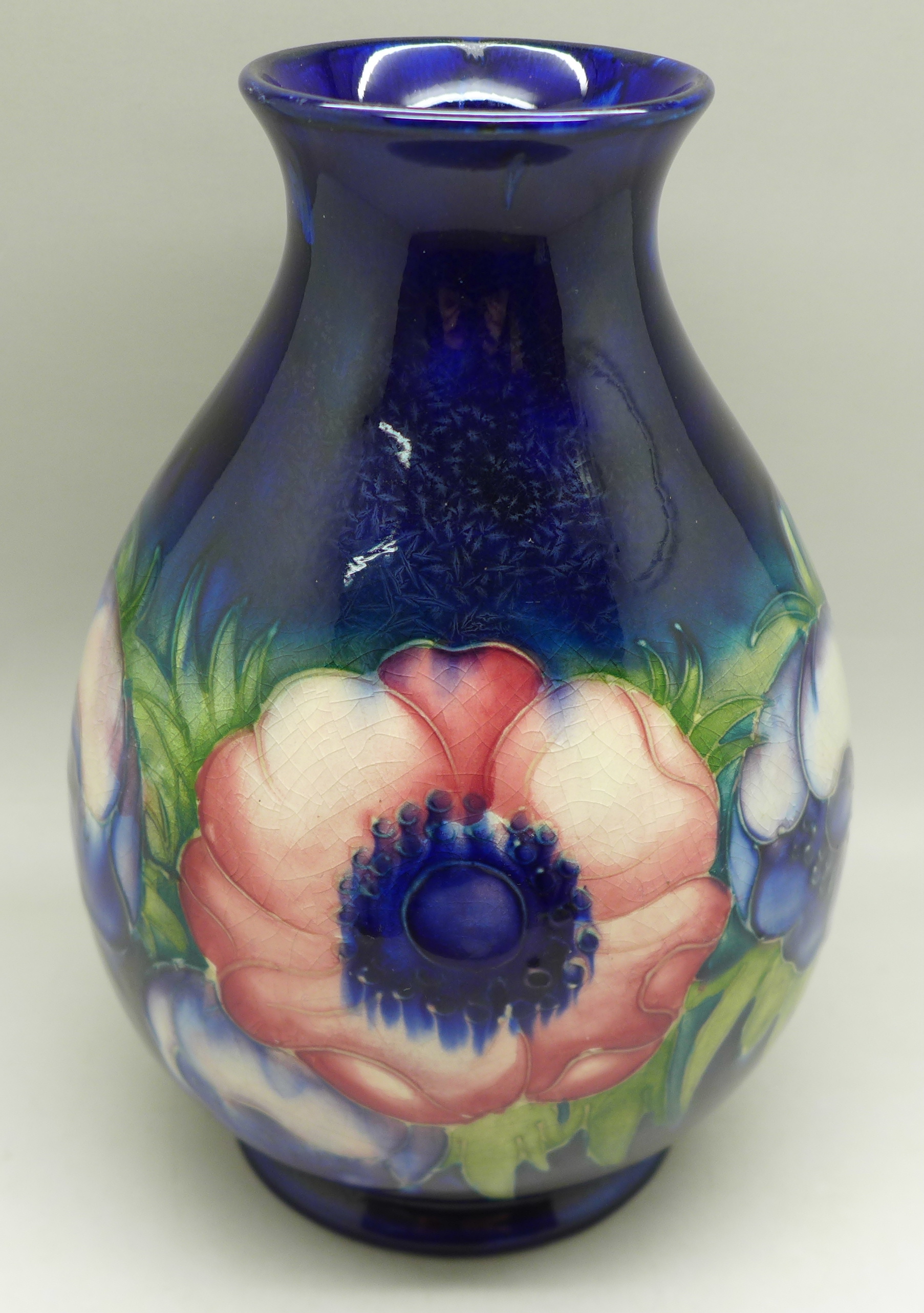 A Moorcroft anemone vase, with signature and impressed marks to the base, 18.5cm