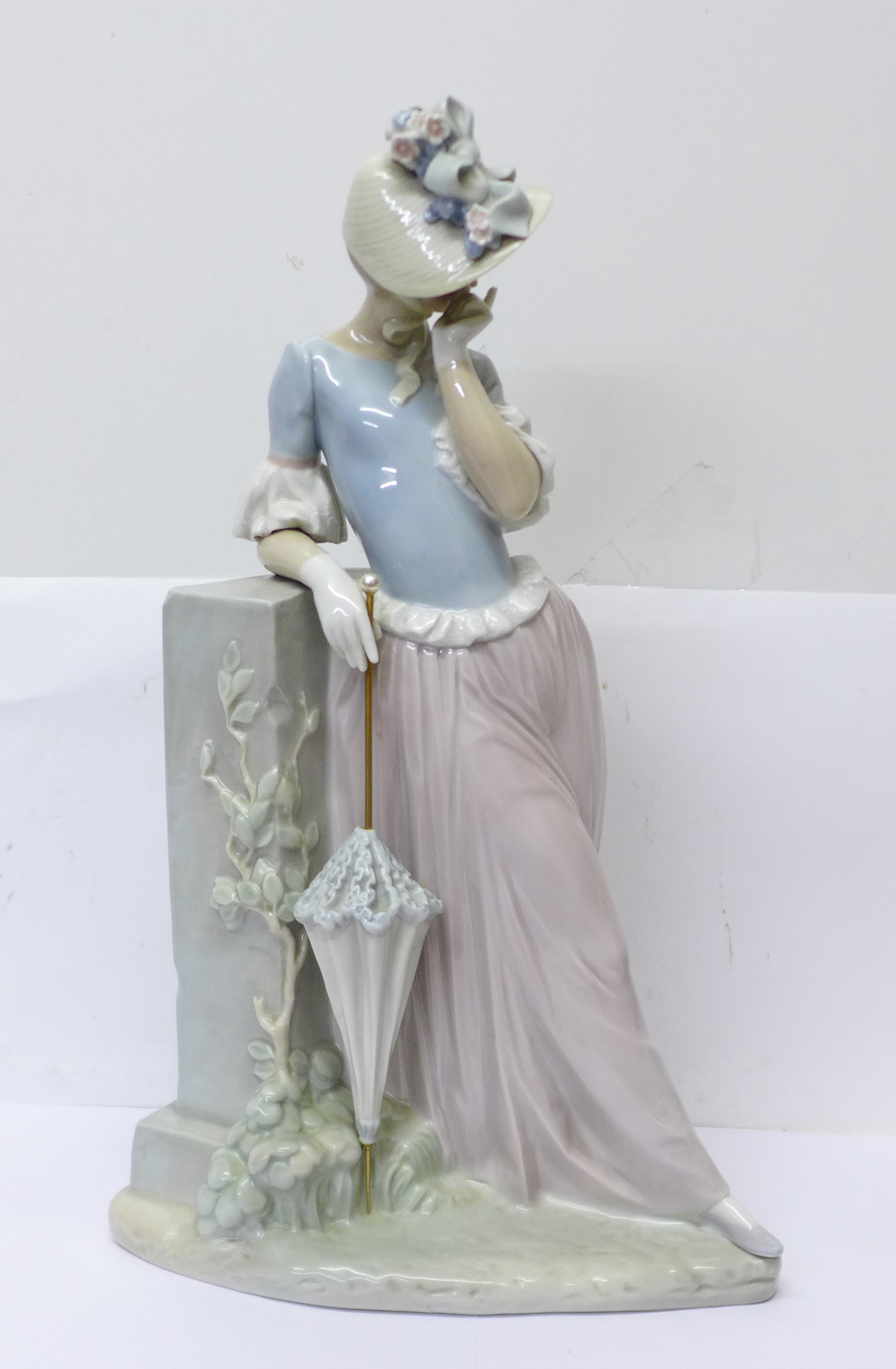 A large Lladro figure of a lady with parasol, 37cm