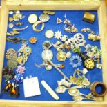 A display case with a silver and amber kilt pin, other silver and costume jewellery, silver