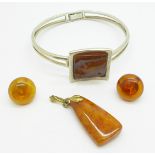 A silver and amber bracelet, maker A.H.J., and an amber set pendant and earrings