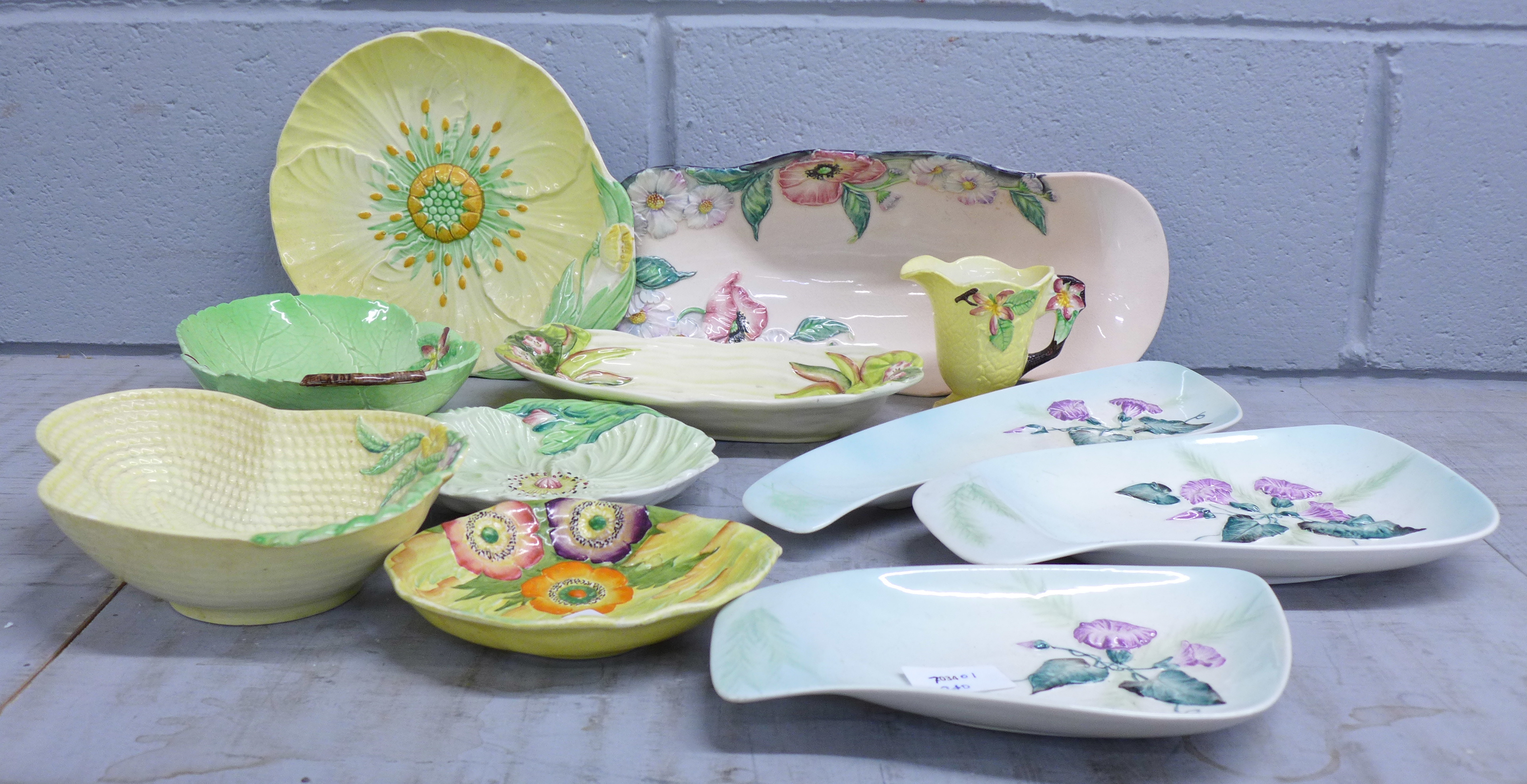 Eight Carlton Ware dishes and a jug and a Clarice Cliff shallow dish, (fault/chip on the Clarice