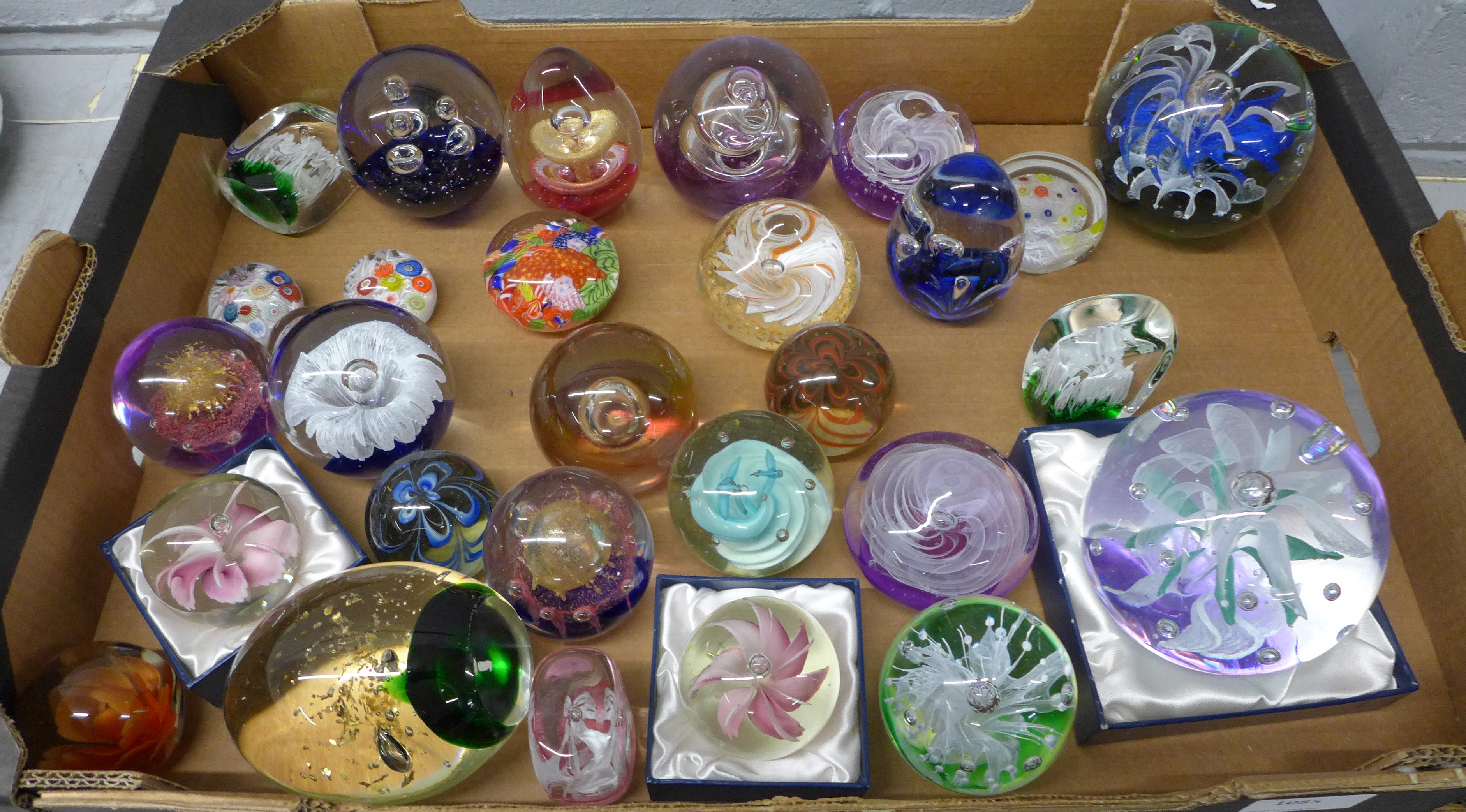 A collection of glass paperweights **PLEASE NOTE THIS LOT IS NOT ELIGIBLE FOR POSTING AND PACKING**