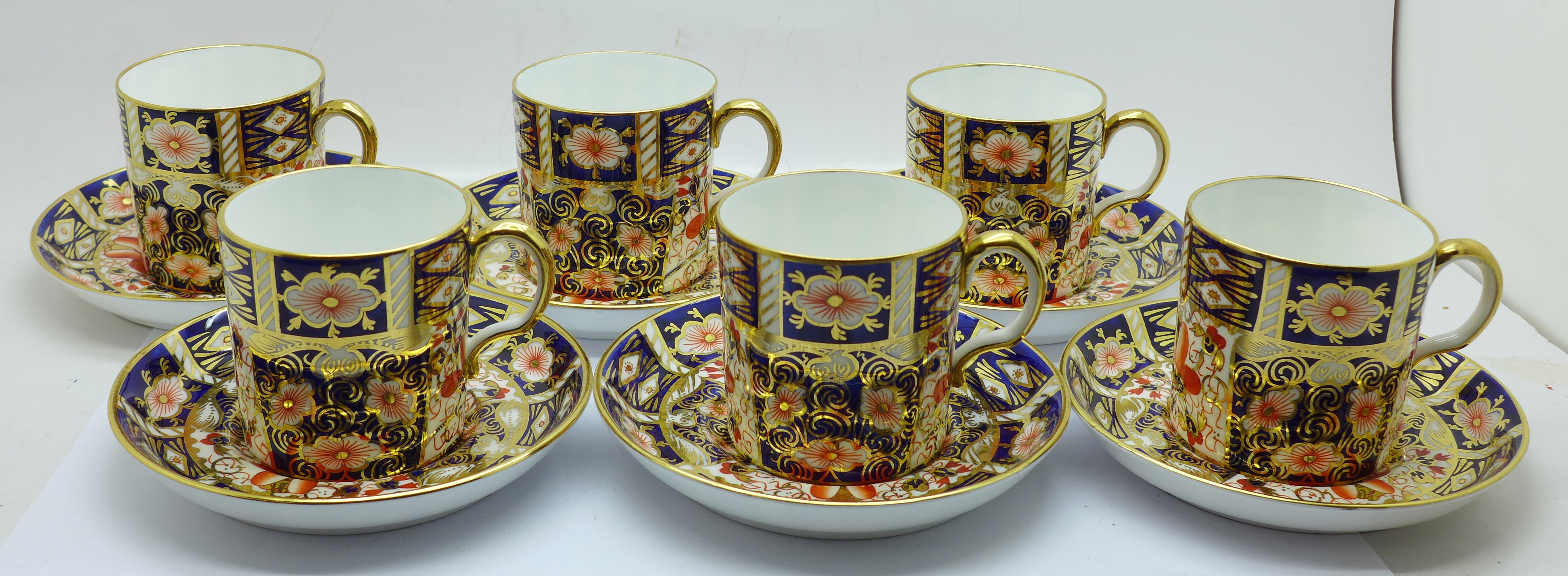 A set of six Royal Crown Derby 2451 coffee cans and saucers