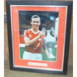 A signed and framed mounted photograph of John McGovern holding the Football League Championship