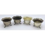 A set of four silver salts, 77.5g, (feet bent)