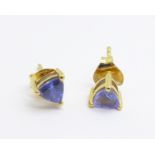 A pair of silver gilt, trilliant cut tanzanite earrings