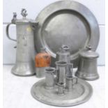 A collection of 18th and 19th Century pewter; large plate, hip flask, graduated measures and a