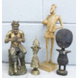 A Nemesis Now Bacchus figure, a carved wooden African fertility figure, a carved wooden figure of