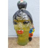 A glass decanter in the form of a Spanish lady