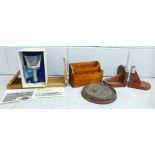 A carved wooden book slide, a pair of wooden book ends, a letter rack, a carved wooden circular