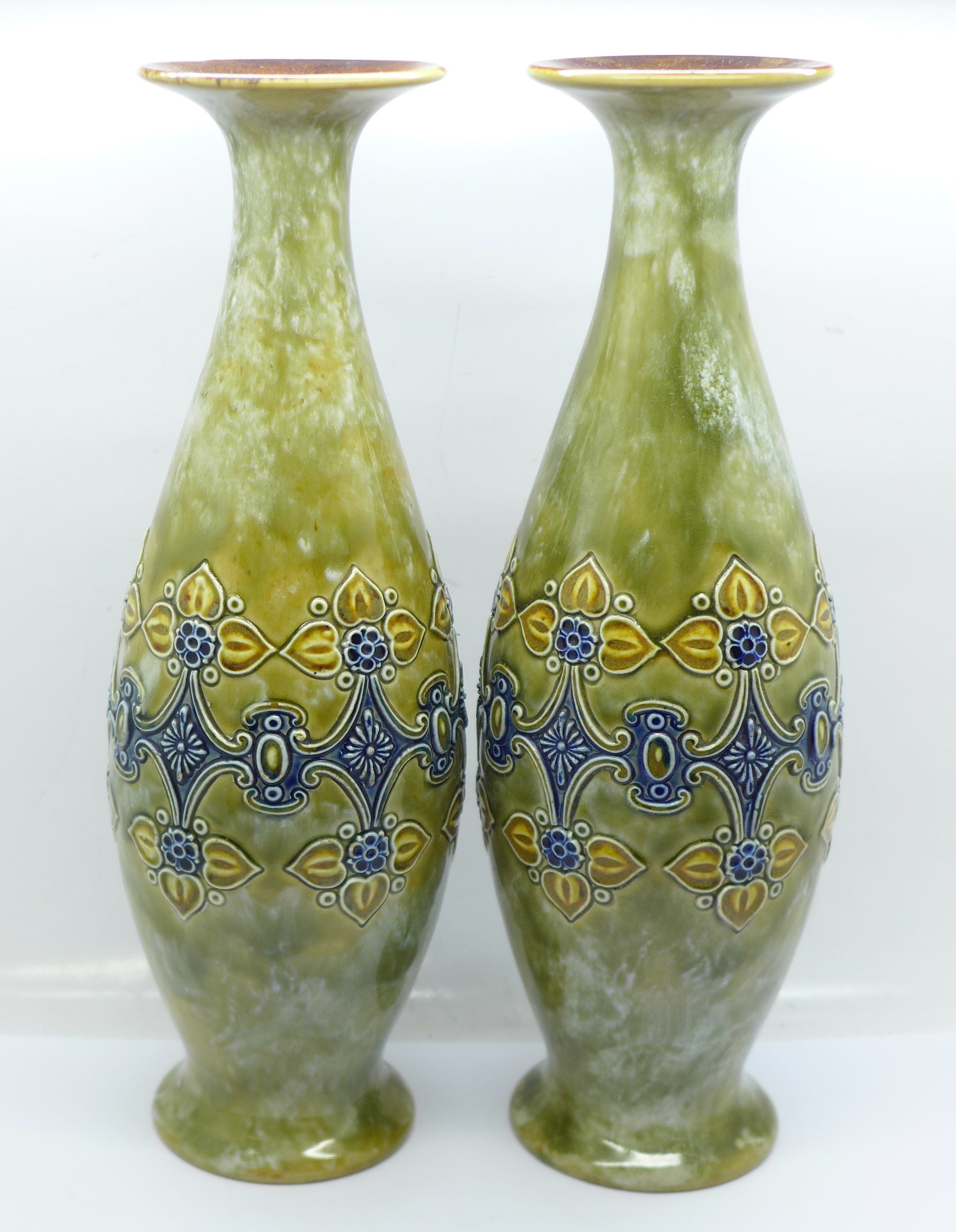 A pair of Royal Doulton saltglaze relief moulded vases, 27cm