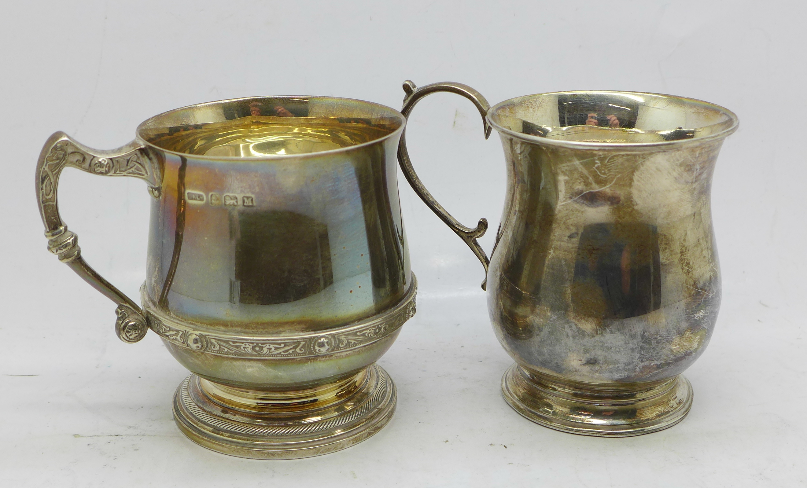 Two silver mugs, one 141g and inscribed '1938', and one 56g