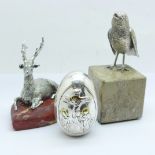 A silver covered egg shaped paperweight marked 950 and two other paperweights, base of stag a/f,