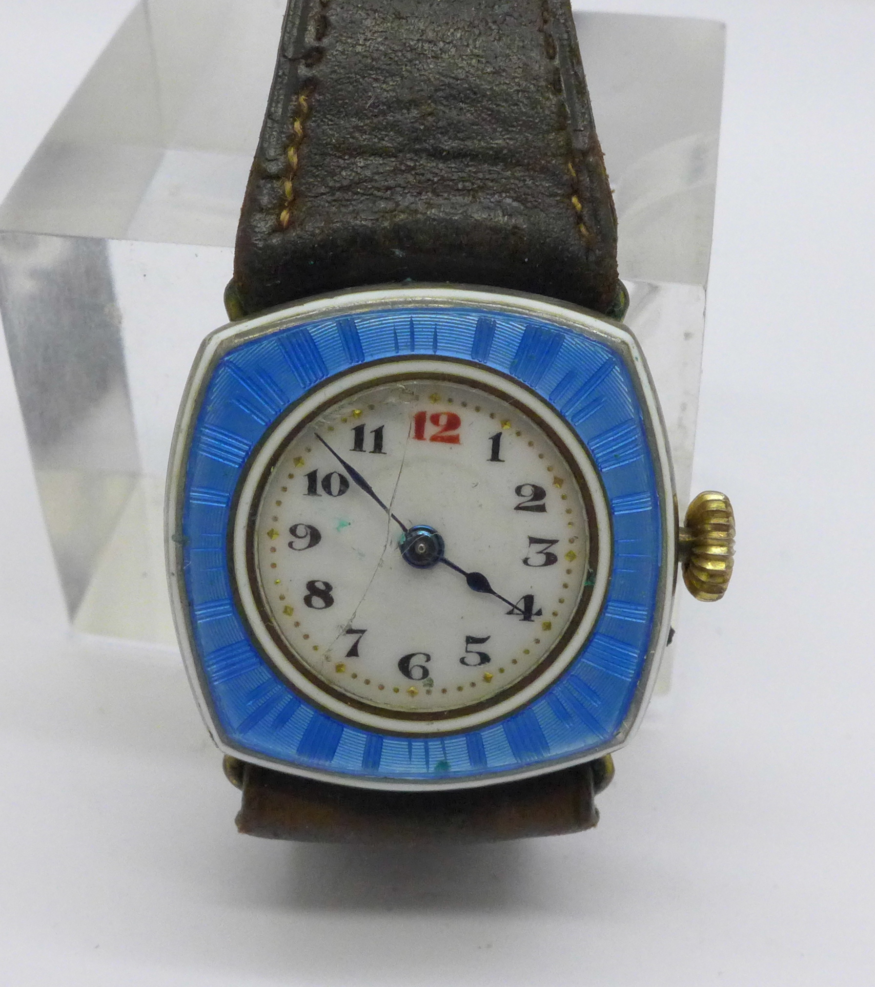 An enamelled wristwatch, glass cracked, the gold plated case back worn, 25mm