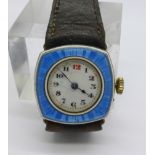 An enamelled wristwatch, glass cracked, the gold plated case back worn, 25mm
