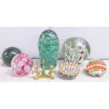 Six glass paperweights including two glass dumps