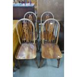 A set of four beech wheelback kitchen chairs