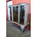 A Queen Anne style bleached walnut serpentine front display cabinet, 152cms h, 130cms w, 50cms d