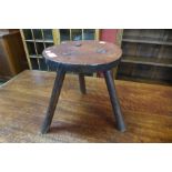 An 18th Century primitive elm three legged stool