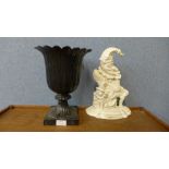 A Victorian cast iron Punch door stop and a small cast iron campana shaped garden urn