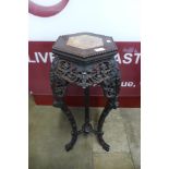 A Chinese carved padouk wood and marble topped hexagonal jardiniere stand, 91cms h