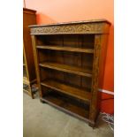 An early 20th Century carved oak open bookcase, 114cms h, 92cms w, 28cms d