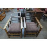 Two similar Arts and Crafts oak reclining armchairs, manner of Liberty & Co.