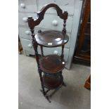 A mahogany folding cake stand