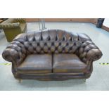 A Thomas Lloyd Chesterfield style brown leather settee, 86cms h, 185cms w, 95cms d