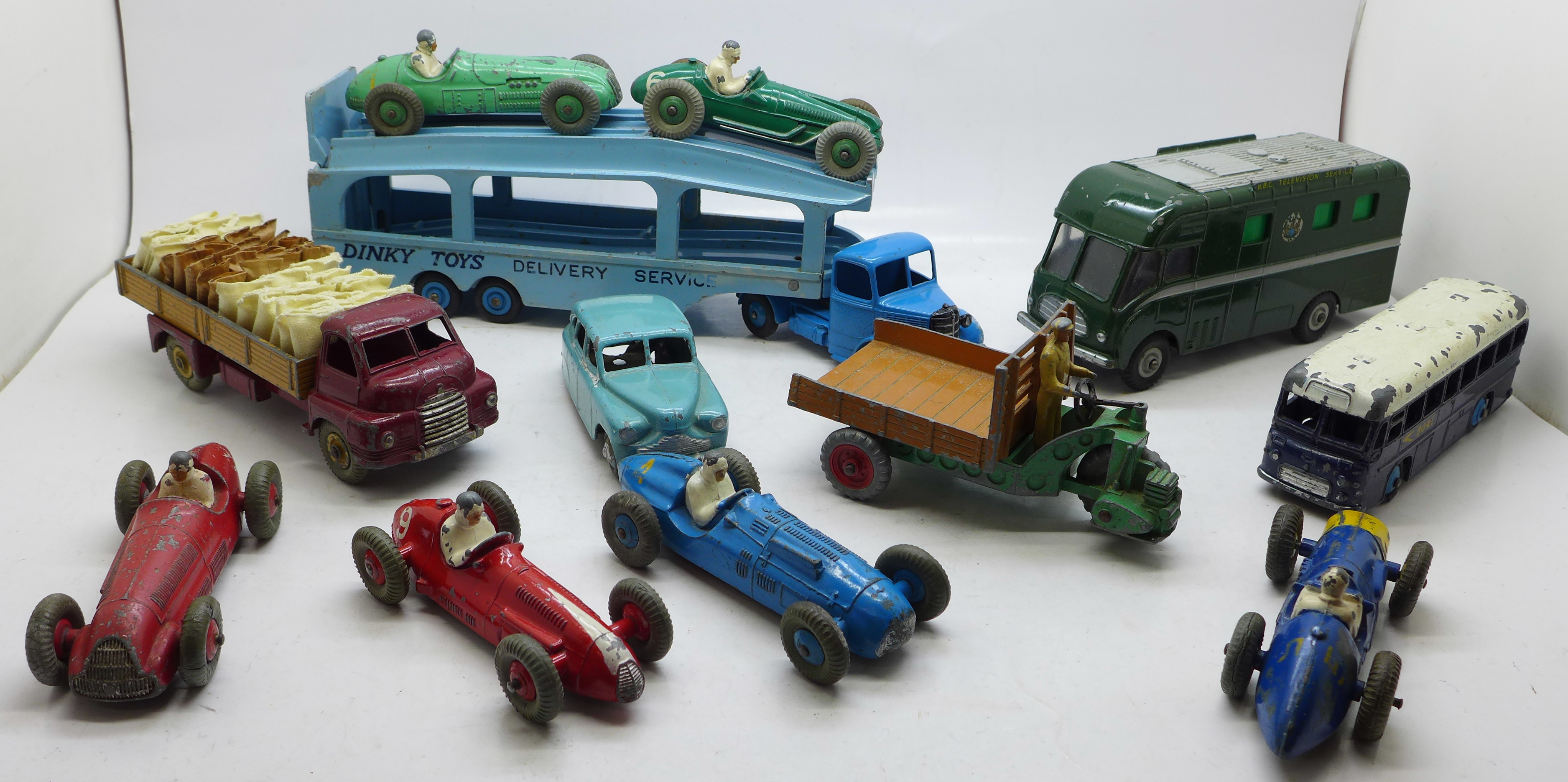 A collection of twelve Dinky Toys model vehicles, including racing cars, BBC Mobile Control Room and