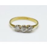 An 18ct gold, three stone diamond ring, 1.9g, M