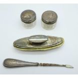 A silver mounted nail buff, manicure and two small silver topped jars, lids dented