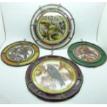 Four circular leaded and coloured glass windows depicting birds, two 21.5cm, two 17.5cm