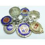 Seven silver cycling fobs, 80g