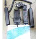 A Motorola Micro TAC Pro mobile phone with charger