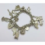 A silver and white metal charm bracelet, with fifteen charms, 66g