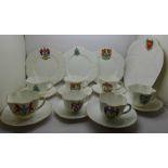 Shelley crested ware; one large plate, three small plates, a saucer, seven cups and six plain