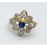 An 18ct gold, sapphire and forty diamond cluster ring, 3.7g, O