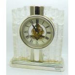 A glass mounted Rhythm quartz clock, height 20cm