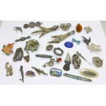 Thirty-two brooches including silver, three a/f, a lapel pin and miniature knife