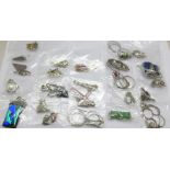 Twenty-five silver pendants and chains