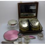 A pair of silver backed brushes, cased, a silver and enamel mirror, a/f, a silver topped glass