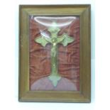 A framed and mounted crucifix under 'domed' glass, width of frame 37cm