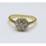 An 18ct gold, platinum set, diamond cluster ring, 2.1g, J