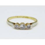 An 18ct gold, platinum set three stone diamond ring, 1.6g, P