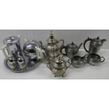 A chrome and ceramic teapot, coffee pot and egg holders with circular tray, a hammered pewter four-